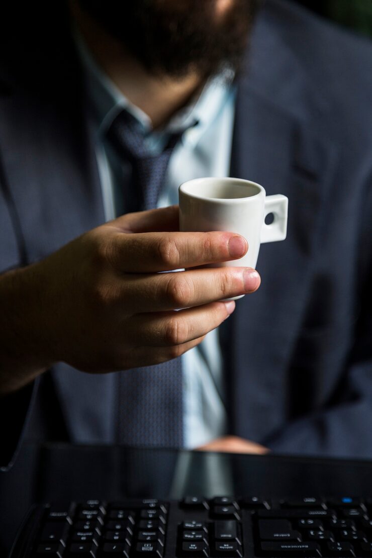 close up businessman s hand holding cup 23 2147860491